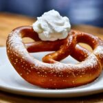 A large freshly baked coffee pretzel